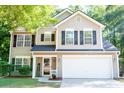 Charming two-story home with a manicured lawn, a two-car garage, and classic architectural details at 109 Holly St, Summerville, SC 29485