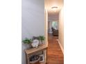 Inviting hallway with wood floors, neutral paint, and decor leading into a bright living space at 109 Holly St, Summerville, SC 29485