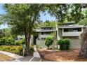 Charming condo with a two-story facade, mature trees, and serene surroundings for a peaceful living experience at 1142 Village Creek Ln # 4, Mount Pleasant, SC 29464