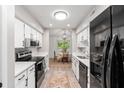 Modern kitchen with white cabinets, stainless steel appliances, and view into a charming dining area perfect for entertaining at 1142 Village Creek Ln # 4, Mount Pleasant, SC 29464