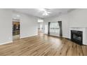 Spacious living room featuring hardwood floors, a ceiling fan, and a cozy fireplace at 1171 Hammrick Ln, Johns Island, SC 29455