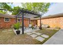 Inviting backyard patio with pergola, seating area, and well-manicured lawn at 1251 Charlestowne Dr, Charleston, SC 29407