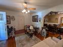 Comfortable living room with hardwood floors, ceiling fan, and decorative furnishings at 1259 Wisteria Rd, Charleston, SC 29407