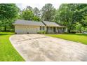 Inviting one-story house featuring an attached garage and a sprawling concrete driveway at 136 Harrow Pl, Goose Creek, SC 29445