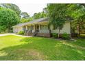 Attractive single story house showcasing manicured landscaping and a cozy covered porch at 136 Harrow Pl, Goose Creek, SC 29445