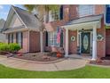 Inviting front entrance features a decorative door, manicured landscaping, and an American flag at 1503 Pondside Ct, Summerville, SC 29485