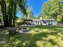 Spacious backyard featuring a pergola-covered patio, fire pit, and lush green lawn perfect for outdoor entertaining at 1534 Kentwood Cir, Charleston, SC 29412