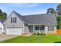 Beautiful gray home featuring a manicured lawn and inviting front porch at 168 Cotillion Cres, Summerville, SC 29483