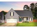 Beautiful gray home featuring a manicured lawn and welcoming front porch at 168 Cotillion Cres, Summerville, SC 29483