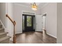 Inviting foyer with hardwood floors, decorative front door, and adjacent staircase at 1708 Waterbrook Dr, Charleston, SC 29414