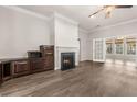 Spacious living room featuring a cozy fireplace, hardwood floors, and French doors to sunroom at 1708 Waterbrook Dr, Charleston, SC 29414