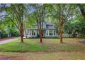 Two-story home with light blue siding, bay windows, mature landscaping, and tall crepe myrtle trees at 1830 Kempton Ave, James Island, SC 29412