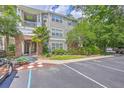 Exterior building view with mature landscaping, multiple trees, and ample parking on a partly cloudy day at 188 Midland Pkwy # 516, Summerville, SC 29485