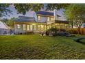 Spacious backyard with a covered porch, screened porch, patio area, and lush lawn at 1901 Bairds Cv, Charleston, SC 29414