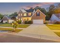 Beautifully landscaped brick home with a two-car garage, covered front porch, and inviting curb appeal at 1901 Bairds Cv, Charleston, SC 29414