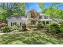 Beautiful two-story home with a inviting front porch and a beautifully landscaped yard with mature trees at 197 High Grove Rd, Summerville, SC 29485