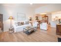 Bright, airy living room featuring white sofa, chairs, and wood flooring at 2011 N Highway 17 # 2300F, Mount Pleasant, SC 29466