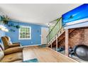 Comfortable living space with hardwood floors, natural light, and a decorative brick feature at 21 Rivers Point Row # Apt 11 C, Charleston, SC 29412
