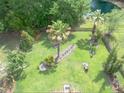 Aerial view of a spacious backyard featuring lush landscaping, a pond, and wooded area at 2132 Summerwood Dr, Mount Pleasant, SC 29466