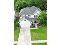 A high angle shot of a beautiful home with manicured lawn and a long driveway leading to a two-car garage at 218 Austin Creek Ct, Summerville, SC 29483