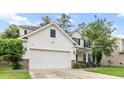 Charming two-story home with a two-car garage, stone accents, lush lawn, and manicured landscaping at 218 Austin Creek Ct, Summerville, SC 29483