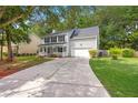 Two-story home featuring an attached garage, extended driveway, and manicured front yard at 240 Eagle Ridge Rd, Summerville, SC 29485