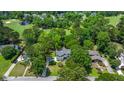 Expansive aerial view of a home surrounded by lush greenery, a golf course, and a serene lake at 25 Fitzroy Dr, Charleston, SC 29414