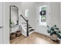 Inviting foyer features a staircase, stylish decor, and a view of the front door at 2844 Pinelog Ln, Johns Island, SC 29455