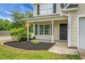 Close-up of the home's charming front porch, showing the well-maintained landscaping and welcoming entrance at 300 Greens Ct, Goose Creek, SC 29445
