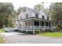 Charming two-story home featuring a spacious wrap-around porch and accessible ramp entry at 3002 Edenvale Rd, Johns Island, SC 29455