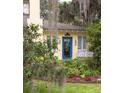 Charming home featuring a blue front door adorned with a wreath, complemented by a lush garden at 34 Formosa Dr, Charleston, SC 29407