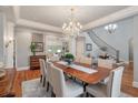 Elegant dining room featuring a large table, chandelier, and access to other living spaces at 3601 Colonel Vanderhorst Cir, Mount Pleasant, SC 29466