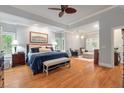 Luxurious main bedroom featuring hardwood floors, tray ceilings, and a cozy sitting area at 3601 Colonel Vanderhorst Cir, Mount Pleasant, SC 29466