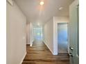 Bright hallway with hardwood floors leads to various rooms in the house at 4147 Rising Tide Dr, Summerville, SC 29485