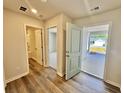 Open door in living space leading to outdoor area and showing bathroom and bedroom doors at 4147 Rising Tide Dr, Summerville, SC 29485