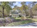 Beautiful two-story home with mature landscaping, covered porch, and a detached two-car garage at 4233 Lady Banks Ln, Ravenel, SC 29470