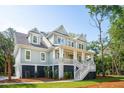 Well-maintained two-story home with a classic design, a lovely front porch, and neatly kept landscaping at 4291 Turtle Landing Ct, Johns Island, SC 29455