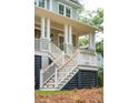 Close-up of a charming front porch with detailed railings, decorative columns, and a welcoming entrance at 4291 Turtle Landing Ct, Johns Island, SC 29455