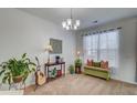 Comfortable living area featuring a chandelier, a guitar, and a green storage bench by the window at 4966 Hay Bale Ct, Summerville, SC 29485