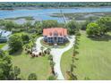 Breathtaking aerial view of estate home with dock on the river in lush green setting at 5625 Crystal Harbor Ln, Hollywood, SC 29449