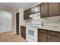 Updated kitchen features a white range, dark cabinetry, and tile flooring at 807 Greencastle Dr, Goose Creek, SC 29445