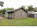 Side view of a home featuring brick and wood siding with a well-maintained lawn at 814 Armsway St, Mount Pleasant, SC 29464