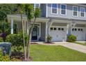 Charming gray townhome with covered front porch, two-car garage, and manicured lawn at 9624 Scarborough Ct, Summerville, SC 29485