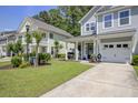 View of the charming gray townhome with well-manicured lawn and covered front porch at 9624 Scarborough Ct, Summerville, SC 29485