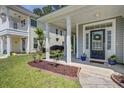 Inviting front porch with landscaping, offering curb appeal at 9624 Scarborough Ct, Summerville, SC 29485