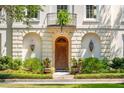 Charming entrance with manicured landscaping and a classic arched doorway, number 174, flanked by lantern sconces at N Blvd, Mount Pleasant, SC 29464