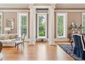 Elegant living room featuring hardwood floors, large windows, and decorative columns for an open feel at N Blvd, Mount Pleasant, SC 29464