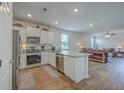 Open kitchen featuring granite countertops, stainless steel appliances, and a center island at 1011 Peridote Way, Ladson, SC 29456