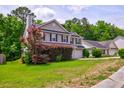 Beautiful two-story home with an attached garage and lush green lawn at 1039 Steelechase Ln, Hanahan, SC 29410