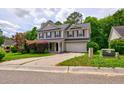 Inviting two-story house with an attached garage and lush landscaping at 1039 Steelechase Ln, Hanahan, SC 29410